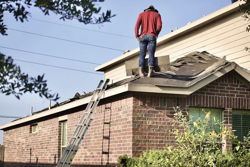 Professional roofer working on a residential roof in High Ridge Acres